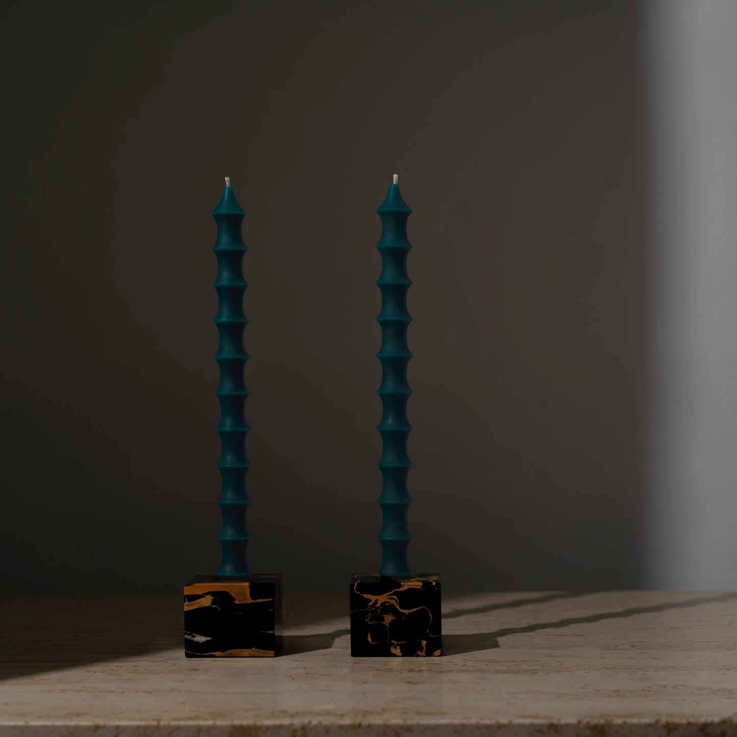 Hand-poured bamboo pagoda-shaped beeswax taper candles in peacock green color, set of two in vintage black marble candleholders with gold veining