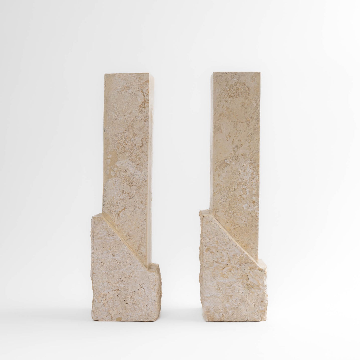 Vintage sculptural travertine candleholder pair with contrasting polished and natural stone textures