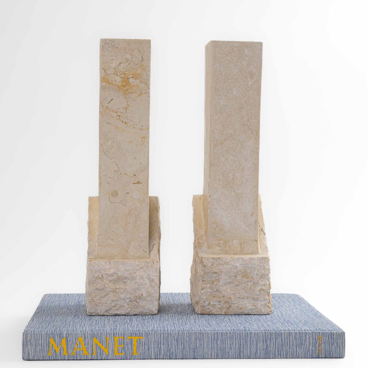 Vintage sculptural travertine candleholder pair with contrasting polished and natural stone textures