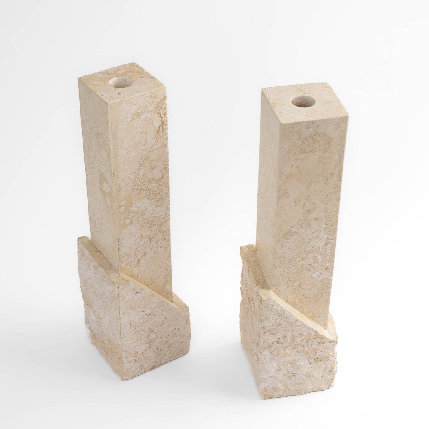 Vintage sculptural travertine candleholder pair with contrasting polished and natural stone textures
