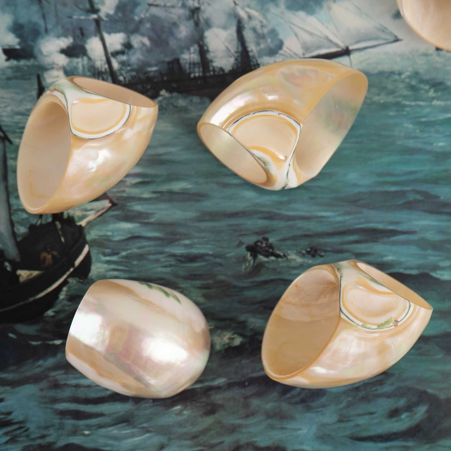 Vintage natural seashell napkin rings set of eight from the 1980s - closeup with a coastal background