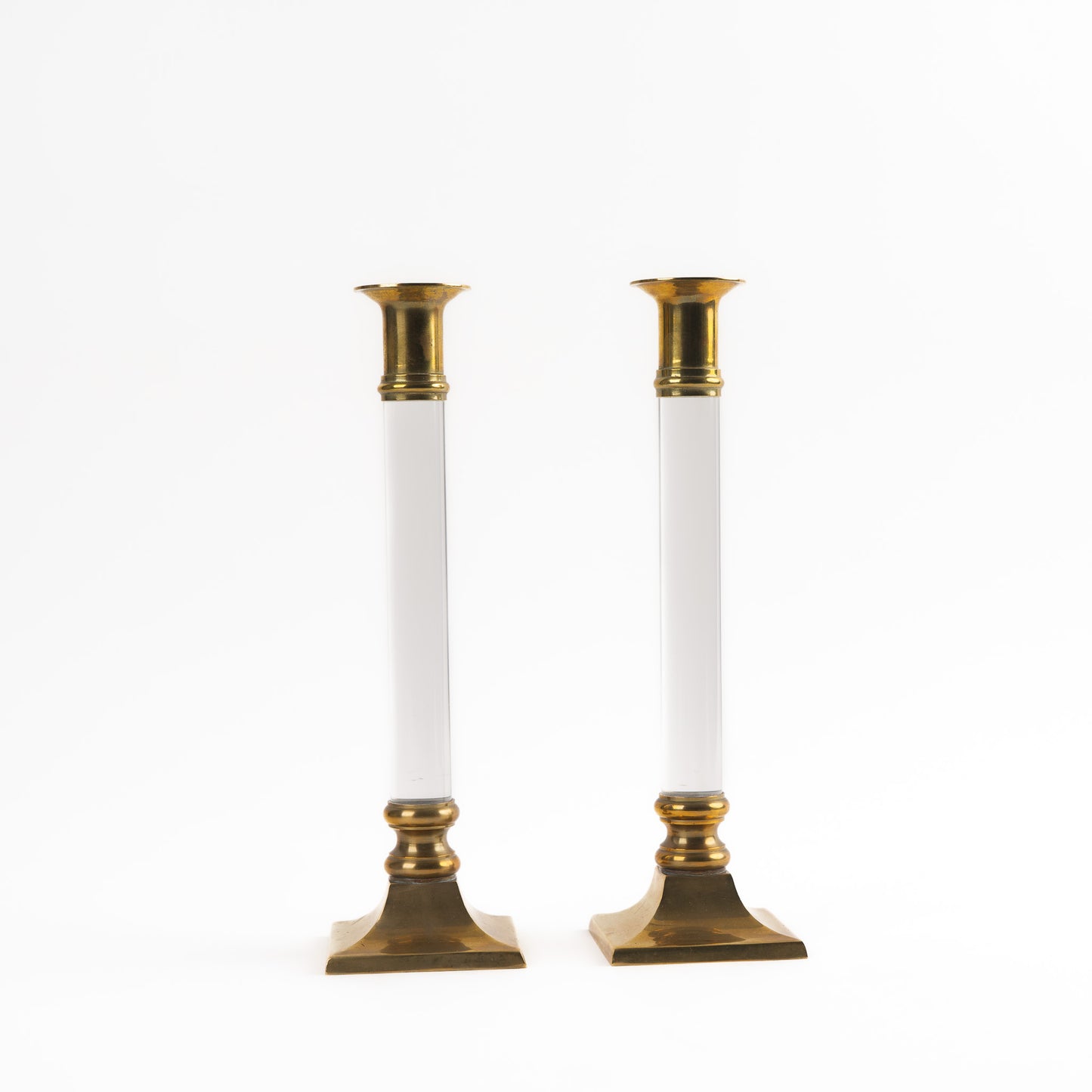 Vintage pair of transparent Lucite candleholders with brass accents for taper candles, styled in Hollywood Regency interior