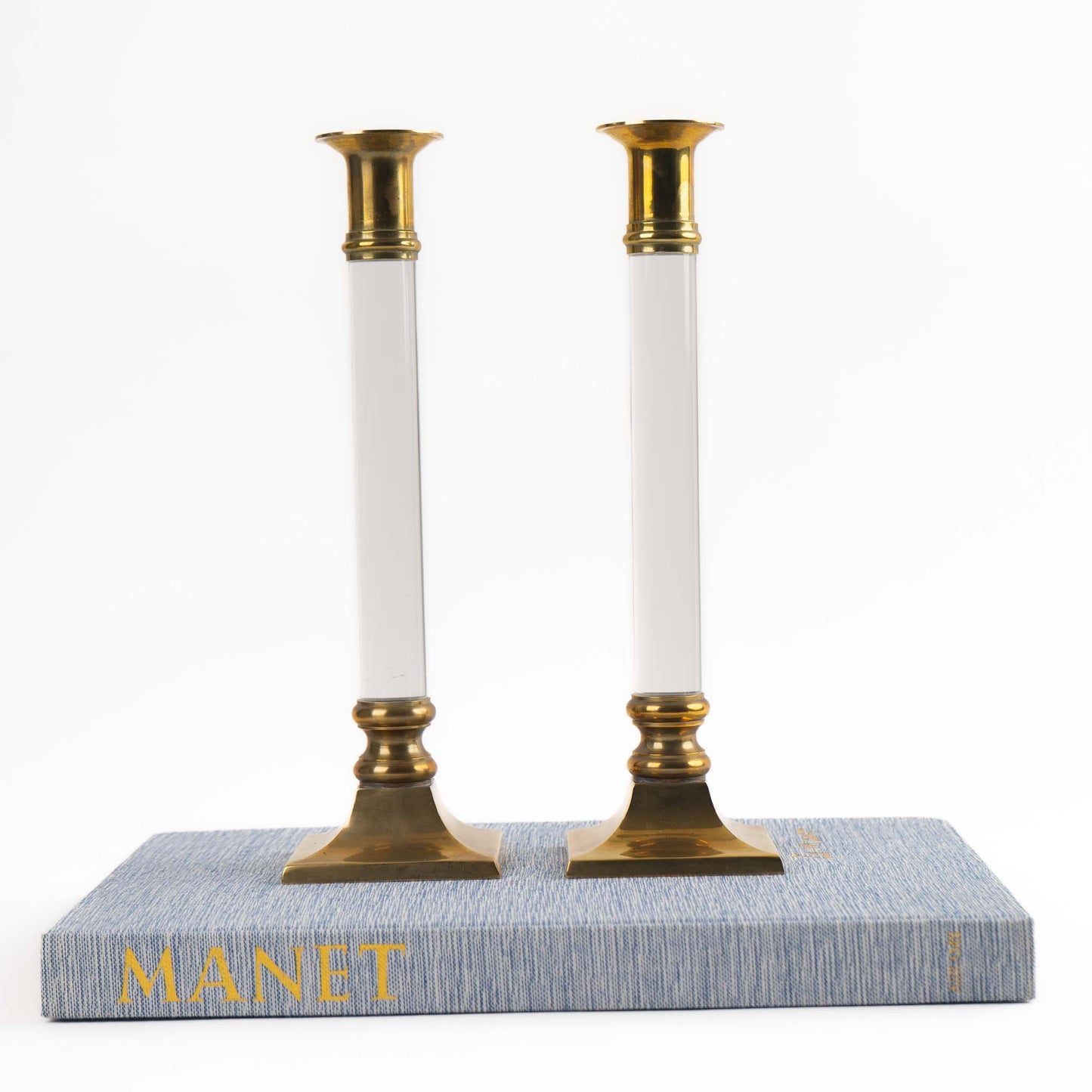 Vintage pair of transparent Lucite candleholders with brass accents for taper candles, styled in Hollywood Regency interior