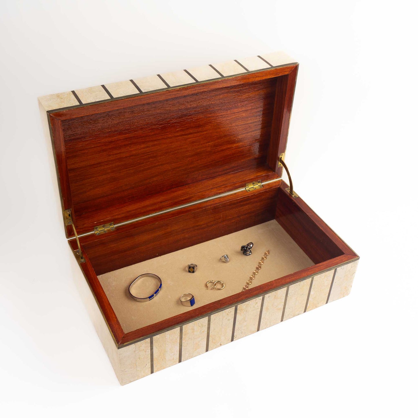 Vintage Maitland Smith tessellated stone jewelry box with brass inlay detailing and hinged lid, showing the interior view styled with vintage gold and silver jewelry