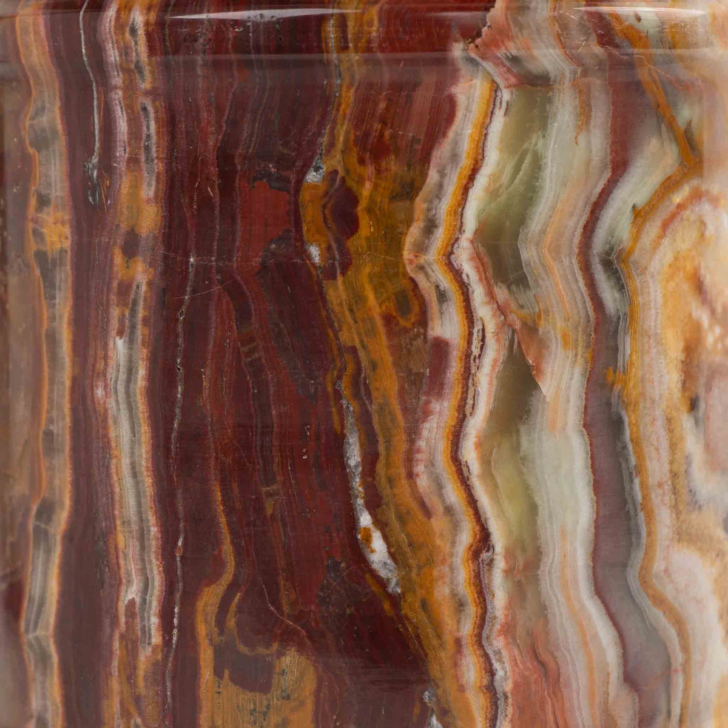 Close-up of red onyx stone texture with natural brown veining patterns