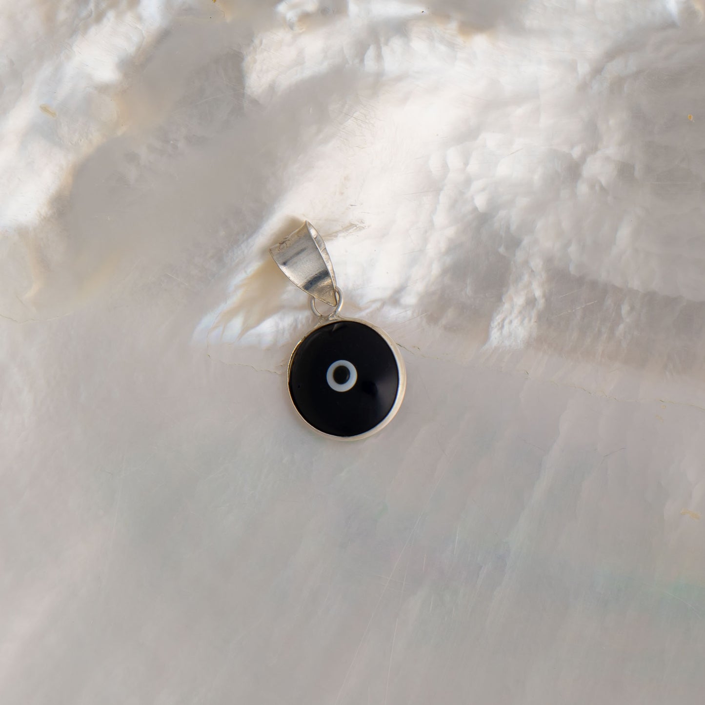 Handcrafted black and white glass evil eye pendant in sterling silver setting, made in Greece