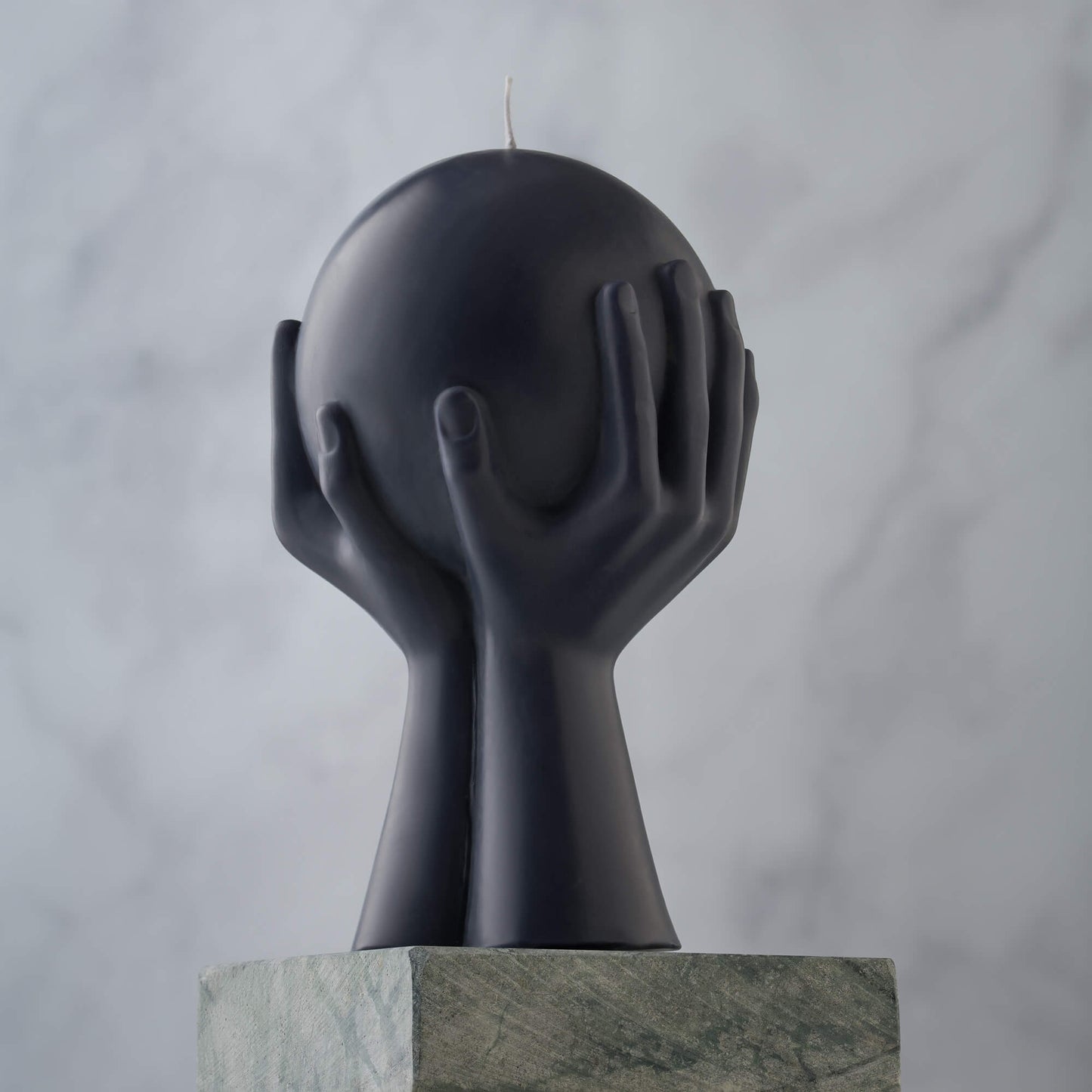 Selene Moon Goddess sculpture candle hand-poured in natural beeswax, photographed on a vintage marble altar. Shown in midnight black.