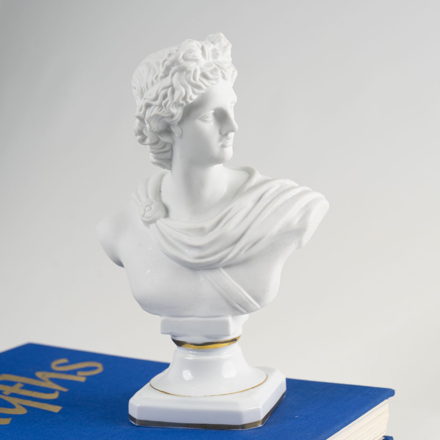 Vintage Apollo Porcelain Bust Figure on a white and gold pedestal