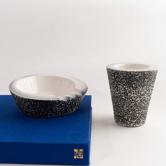 Load image into Gallery viewer, 1960s ceramic ashtray with matching pencil cup organizer in black and white speckled texture 
