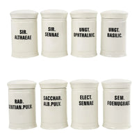 Off-white ceramic apothecary jars with black vintage lettering and matching lids 