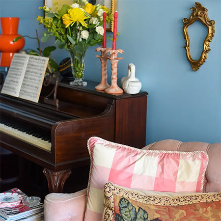 Asparagus taper candles in vintage palmtree candle holders. Living room makeover seen on Apartment Therapy
