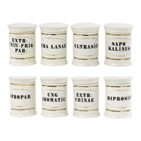 Set of 8 off-white ceramic apothecary jars with gold accents and vintage pharmaceutical-style lettering, each with matching lid