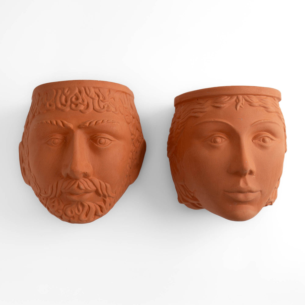 
                  
                    Pair of vintage Rookes Pottery terracotta wall planters featuring mythological god and goddess faces, made in England
                  
                