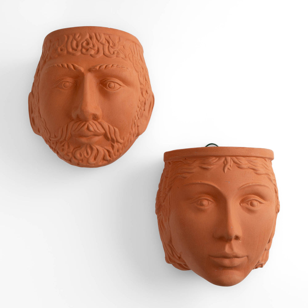 
                  
                    Pair of vintage Rookes Pottery terracotta wall planters featuring mythological god and goddess faces, made in England
                  
                