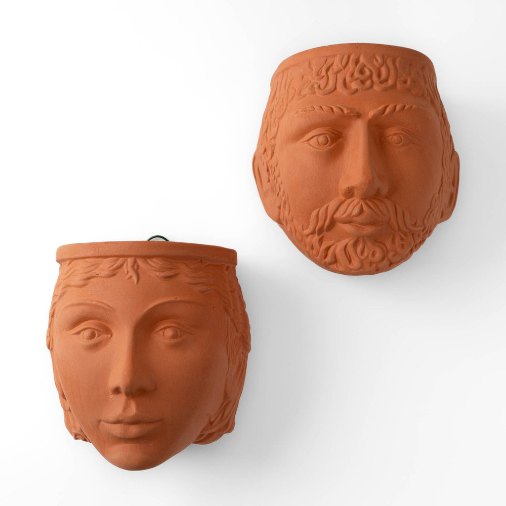 
                  
                    Pair of vintage Rookes Pottery terracotta wall planters featuring mythological god and goddess faces, made in England
                  
                