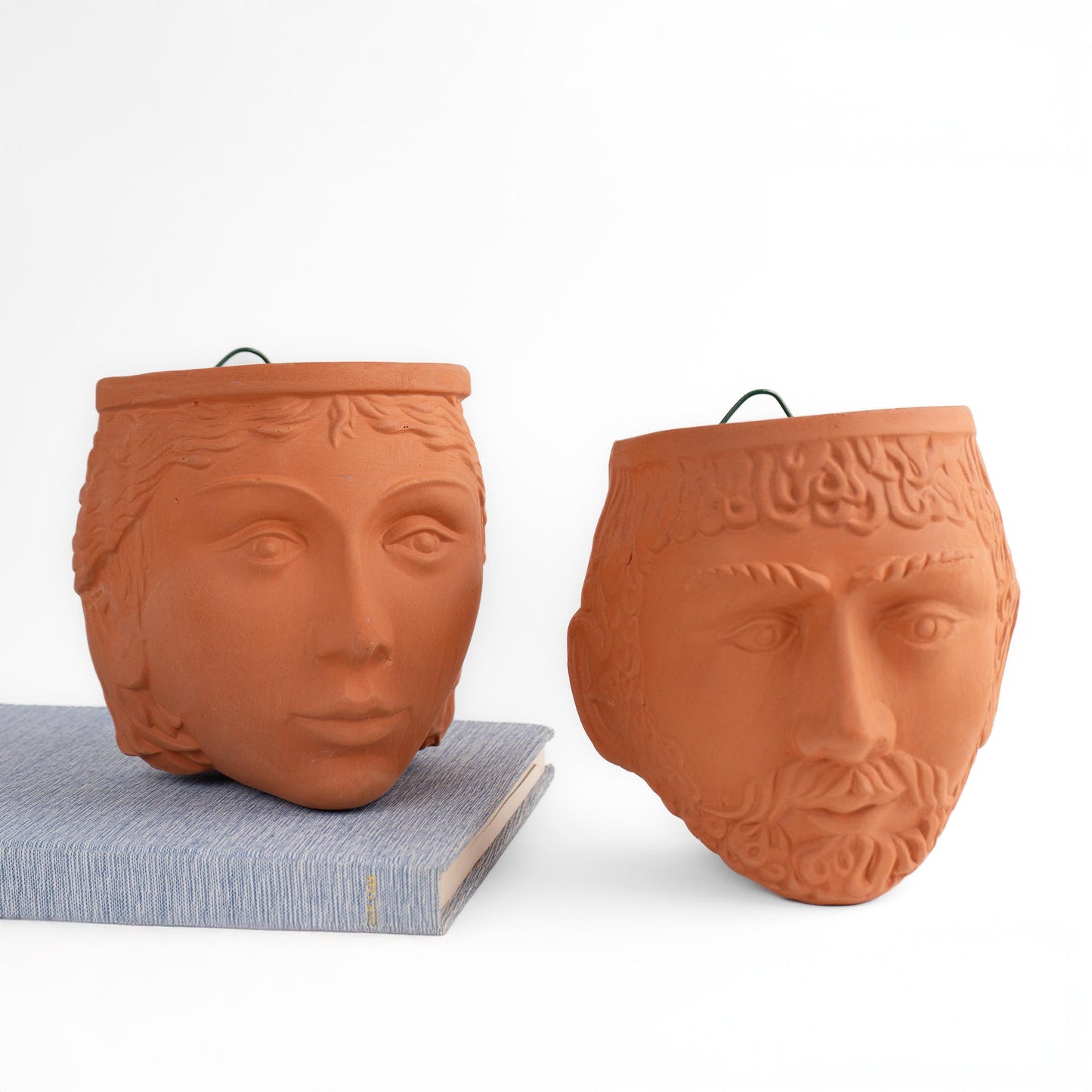 Pair of vintage Rookes Pottery terracotta wall planters featuring mythological god and goddess faces, made in England