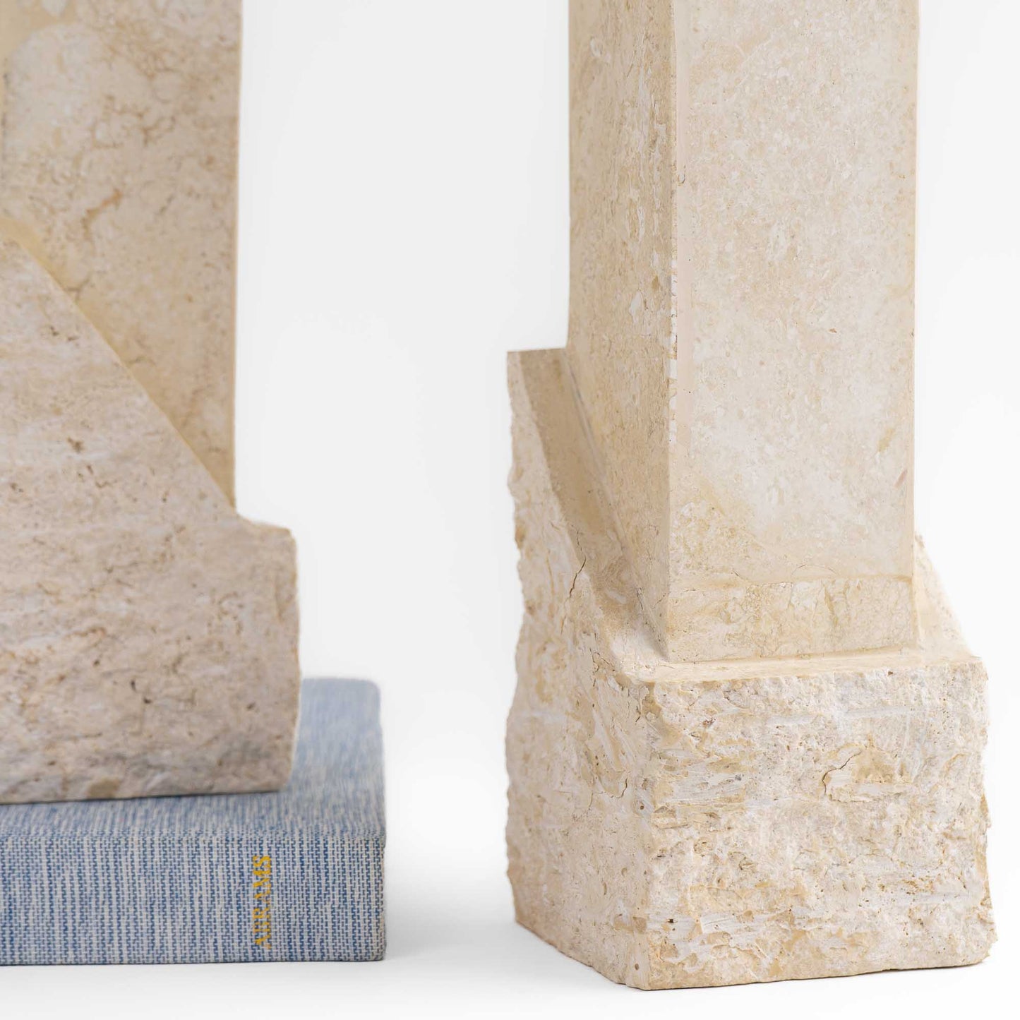 Vintage sculptural travertine candleholder pair with contrasting polished and natural stone textures