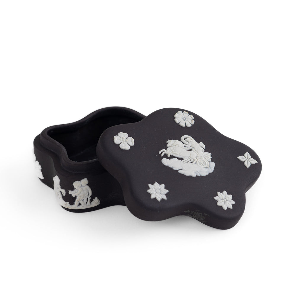 
                  
                    Vintage star-shaped Wedgwood black jasperware trinket box with white relief of Aurora Goddess of Dawn and cherub motifs, 1970s collectible.
                  
                