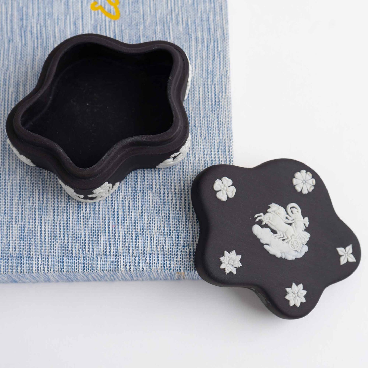 Vintage star-shaped Wedgwood black jasperware trinket box with white relief of Aurora Goddess of Dawn and cherub motifs, 1970s collectible.