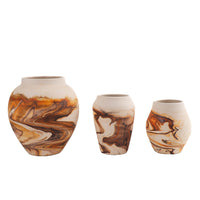 Vintage Nemadji pottery vase collection showing three handcrafted vessels with swirled brown, tan and orange patterns, each marked with authentic Nemadji Pottery USA 