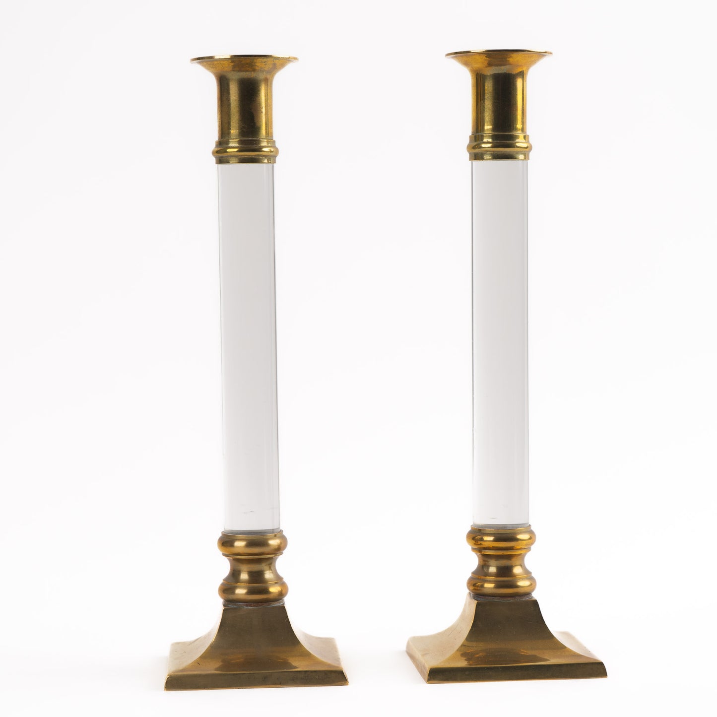 Vintage pair of transparent Lucite candleholders with brass accents for taper candles, styled in Hollywood Regency interior