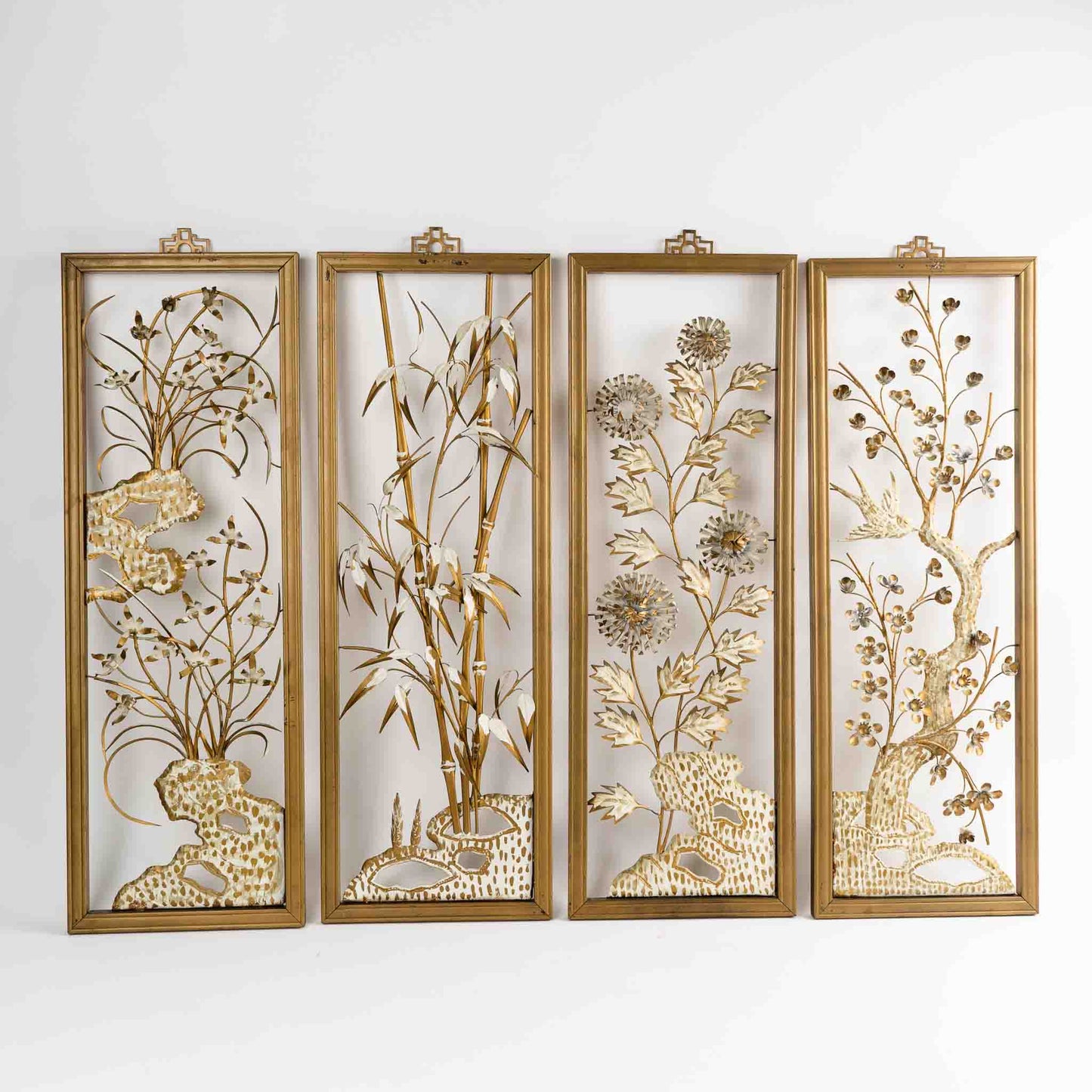 Vintage mid-century dimensional metal flower wall art in gold-tone wooden frames, featuring sculpted gold and cream botanical elements, circa 1950s-1960s