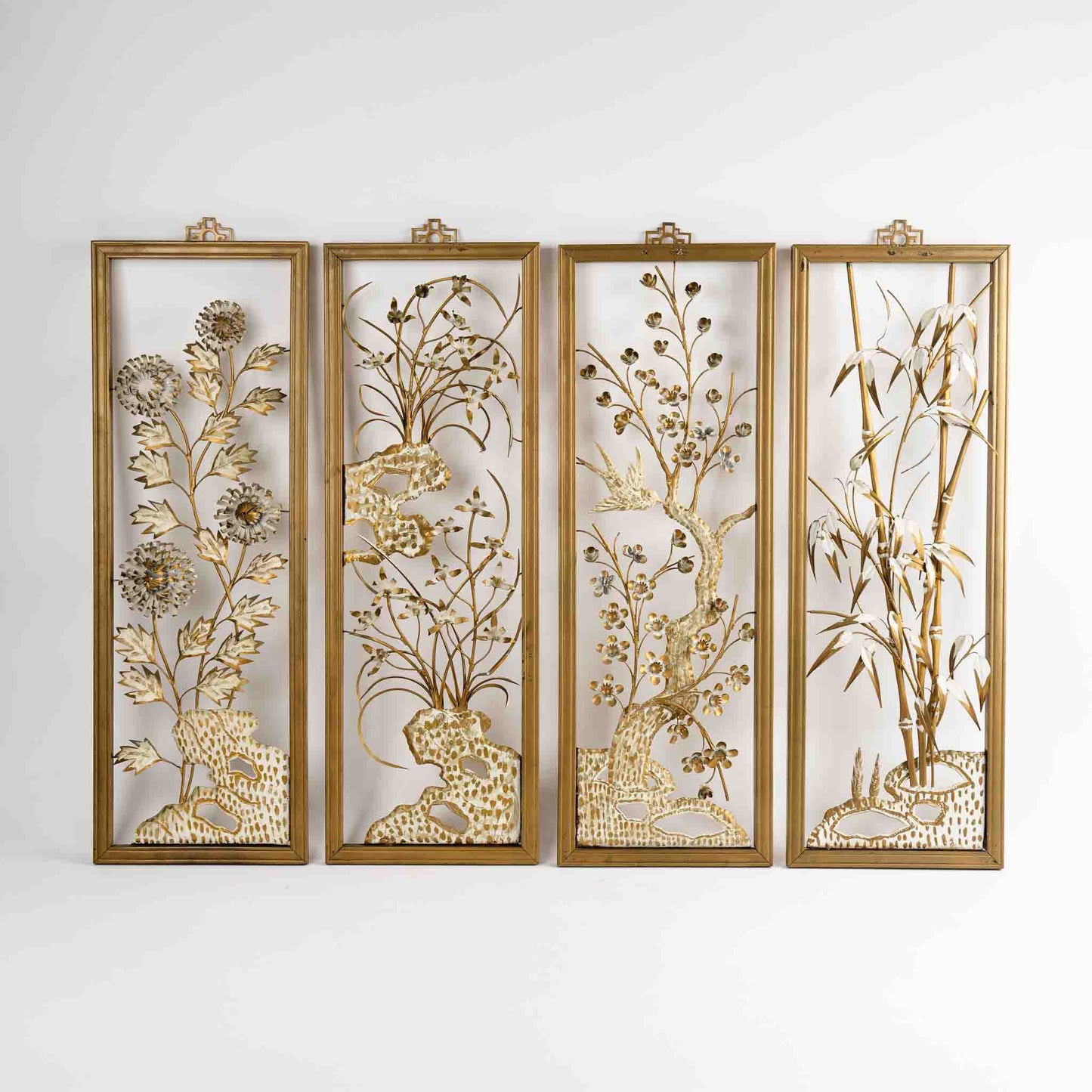 Vintage mid-century dimensional metal flower wall art in gold-tone wooden frames, featuring sculpted gold and cream botanical elements, circa 1950s-1960s