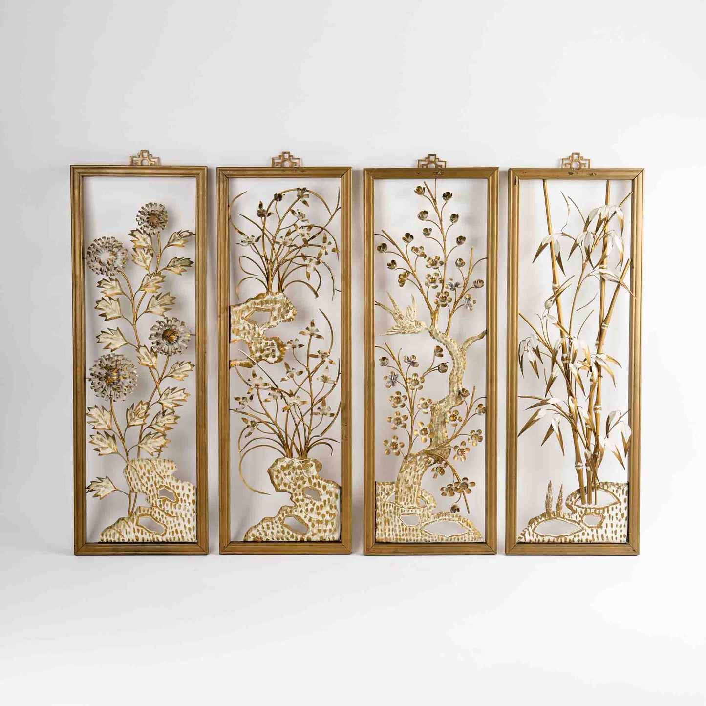 Vintage mid-century dimensional metal flower wall art in gold-tone wooden frames, featuring sculpted gold and cream botanical elements, circa 1950s-1960s