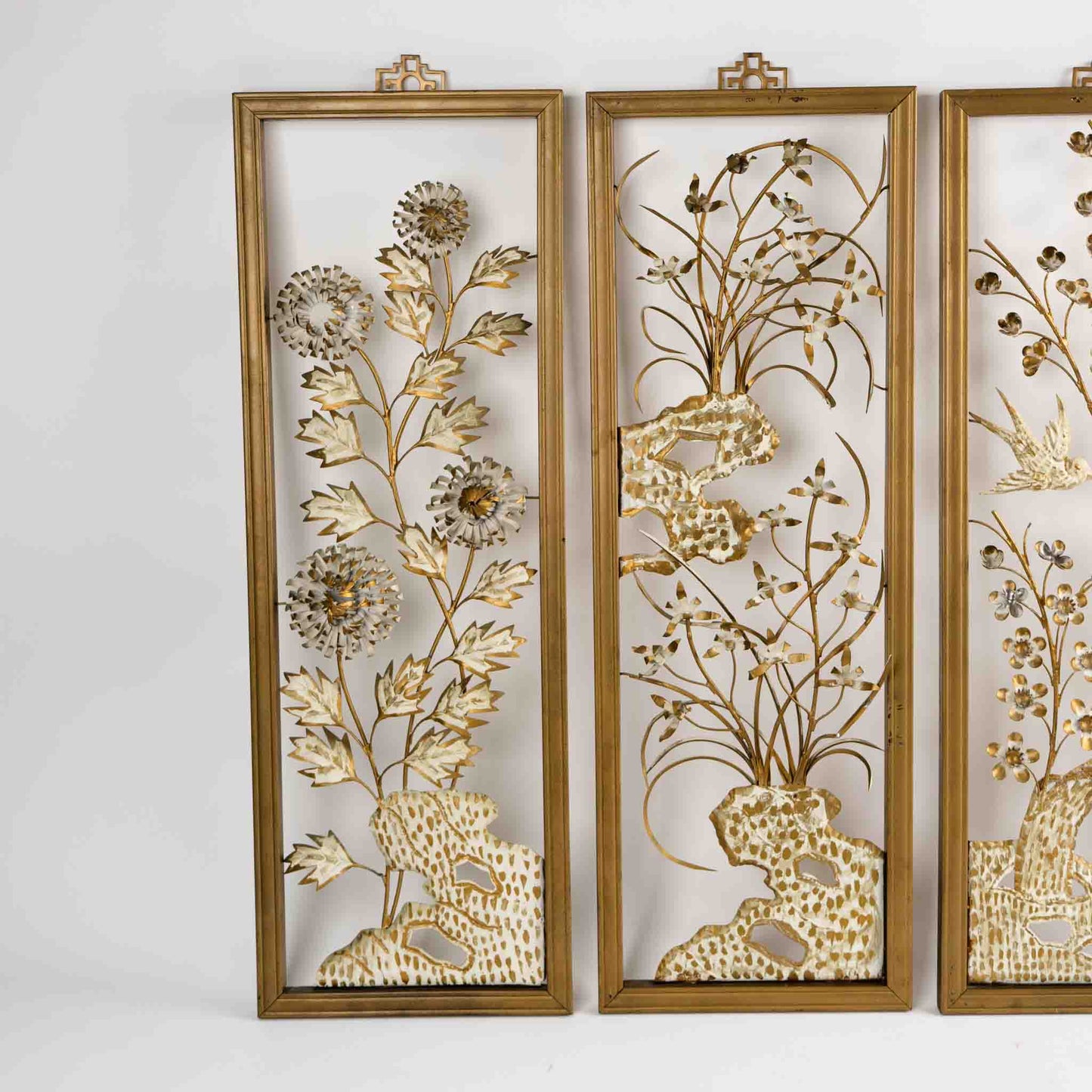 Vintage mid-century dimensional metal flower wall art in gold-tone wooden frames, featuring sculpted gold and cream botanical elements, circa 1950s-1960s