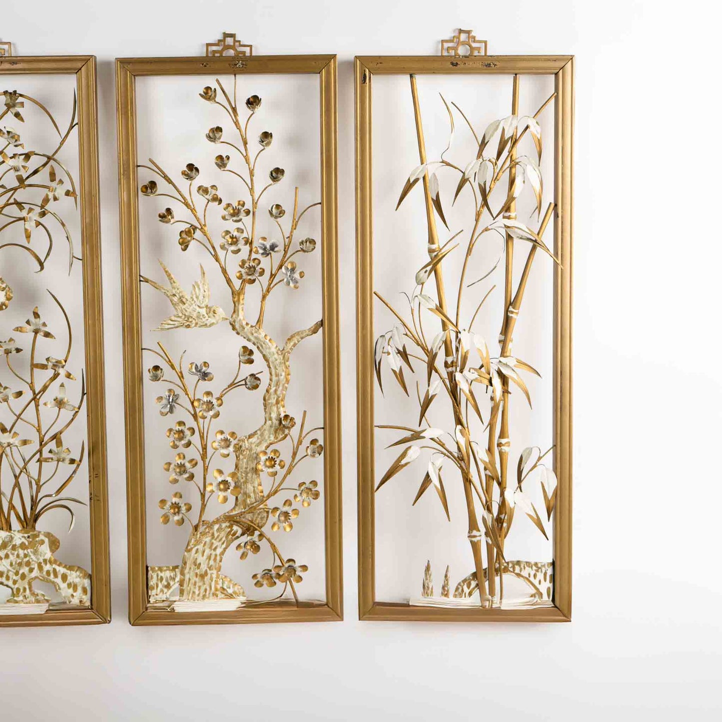 Vintage mid-century dimensional metal flower wall art in gold-tone wooden frames, featuring sculpted gold and cream botanical elements, circa 1950s-1960s