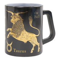 Vintage black coffee mug with gold Taurus zodiac bull design from the 1950s-60s, perfect for coffee or desk organization