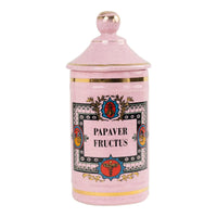 Vintage pink ceramic apothecary jar with gold trim and papaver fructus lettering on speckled glaze background