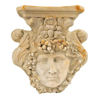 Vintage Hayes Parker plaster wall sconce shelf with classical Roman face design, scroll and acanthus leaf details, and integrated planter pocket in antique sandstone finish