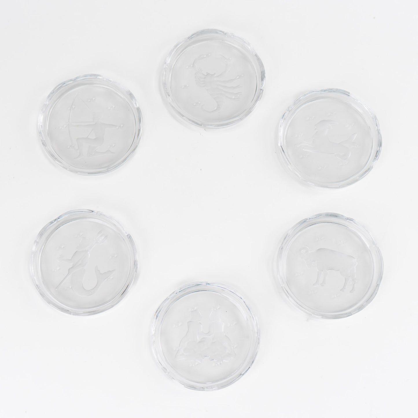 Set of six vintage crystal coasters with zodiac signs by Val Saint Lambert, featuring scalloped edges and frosted intaglio designs
