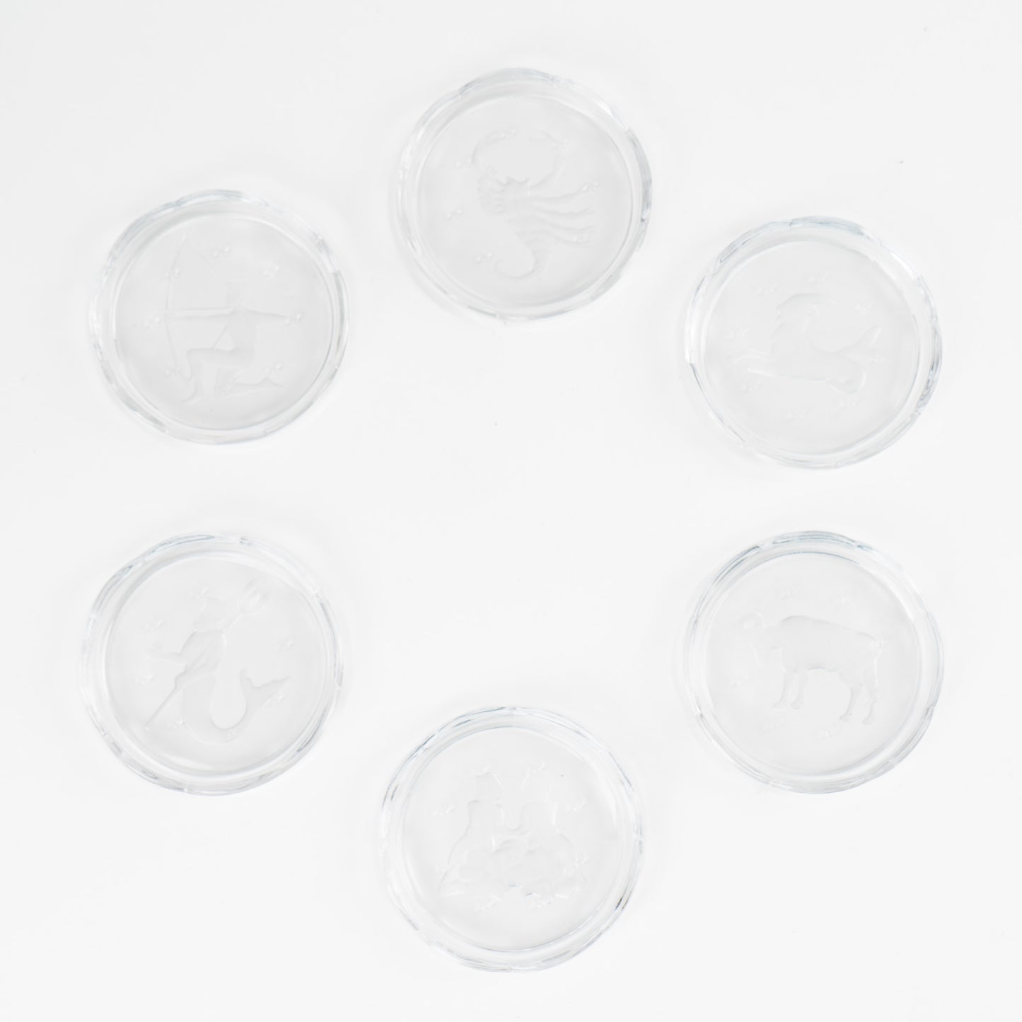 Set of six vintage crystal coasters with zodiac signs by Val Saint Lambert, featuring scalloped edges and frosted intaglio designs