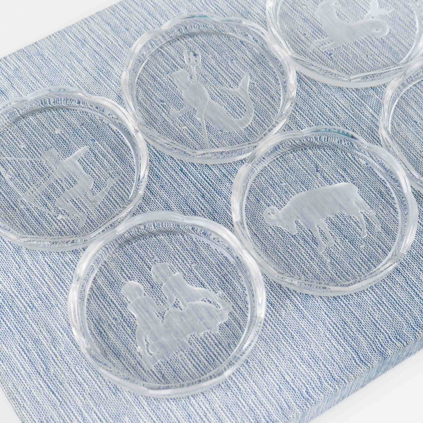 Set of six vintage crystal coasters with zodiac signs by Val Saint Lambert, featuring scalloped edges and frosted intaglio designs