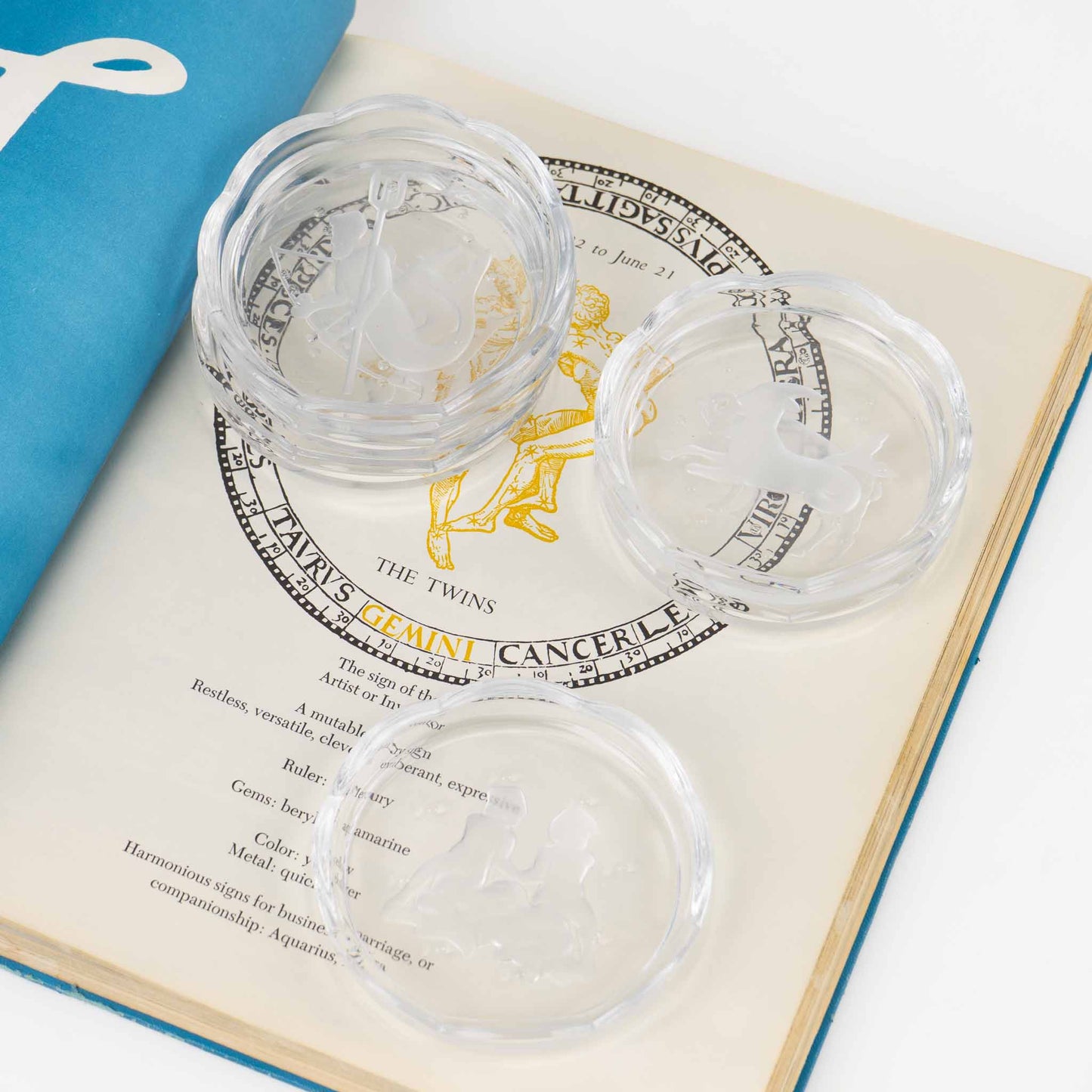 Set of six vintage crystal coasters with zodiac signs by Val Saint Lambert, featuring scalloped edges and frosted intaglio designs