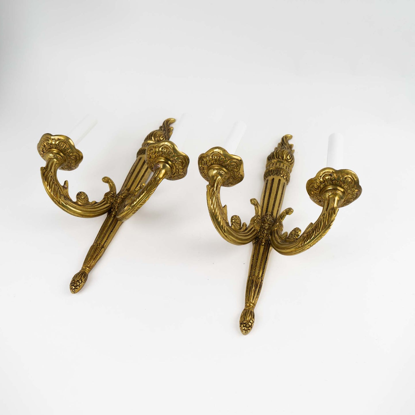 Pair of vintage brass wall sconces in ornate Louis XV style with decorative scrollwork and dual bulb holders