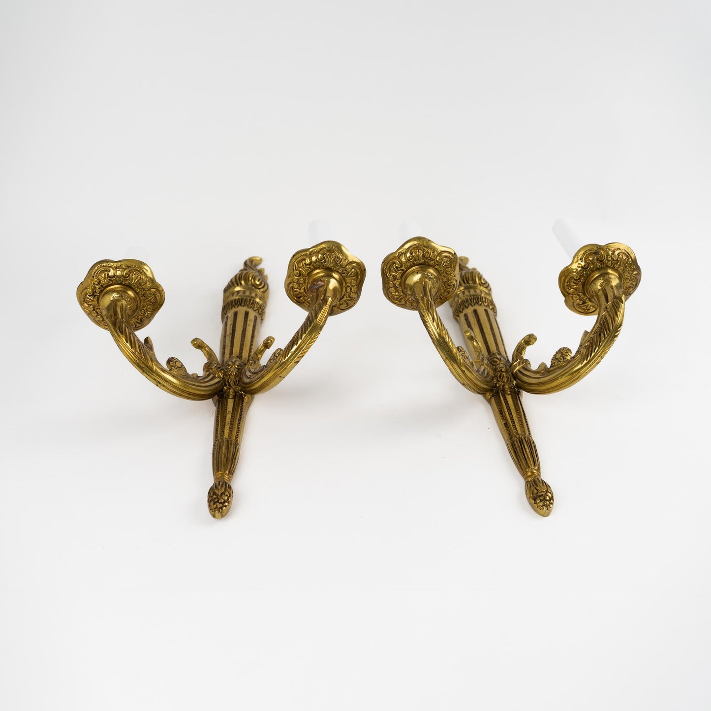 Pair of vintage brass wall sconces in ornate Louis XV style with decorative scrollwork and dual bulb holders