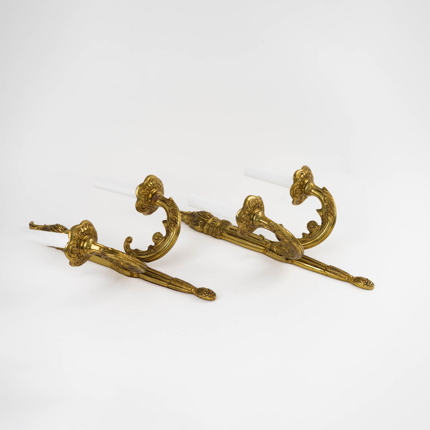 Pair of vintage brass wall sconces in ornate Louis XV style with decorative scrollwork and dual bulb holders