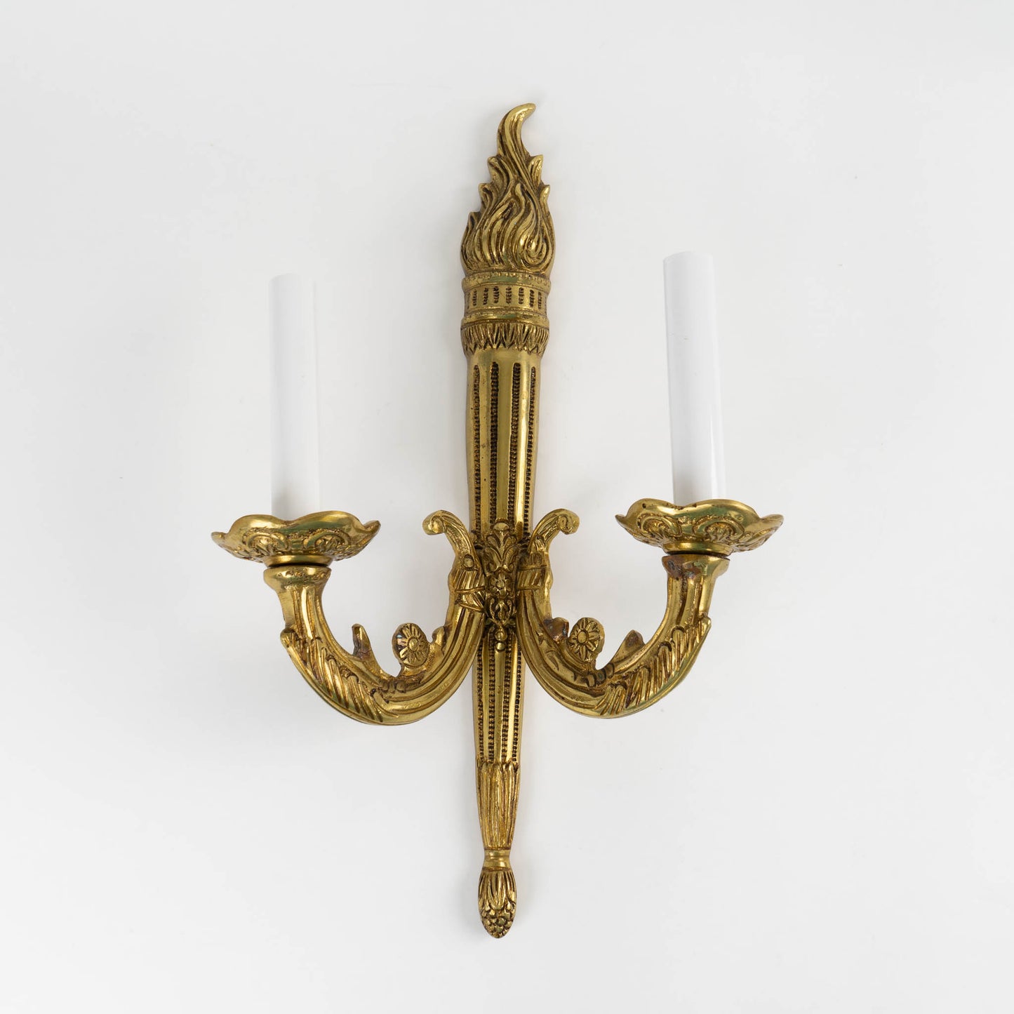 vintage brass wall sconce in ornate Louis XV style with decorative scrollwork and dual bulb holders