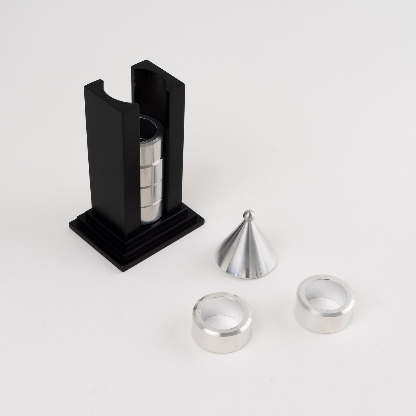 Vintage black building-shaped napkin ring holder displaying six silver metal napkin rings for elegant table setting storage