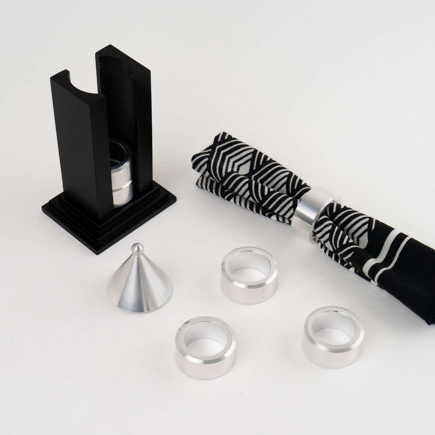 Vintage black building-shaped napkin ring holder displaying six silver metal napkin rings for elegant table setting storage