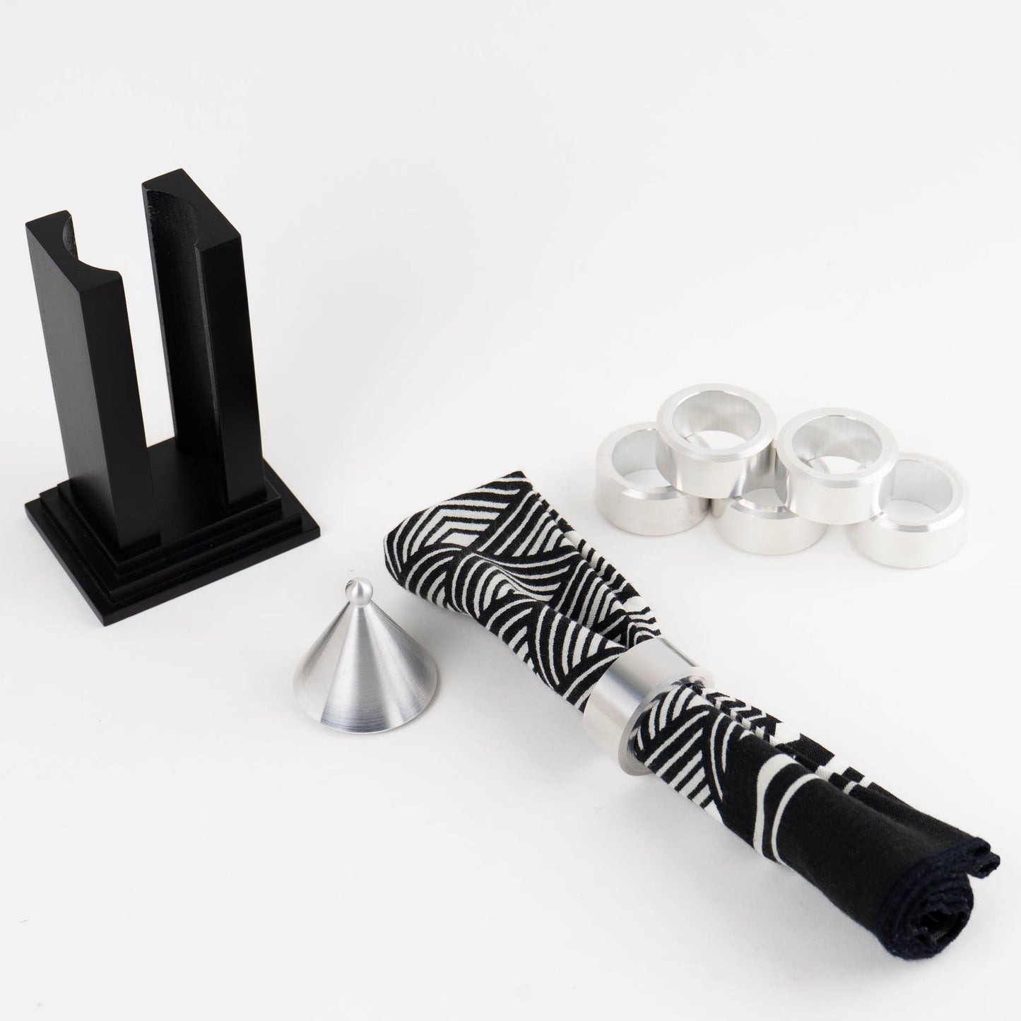 Vintage black building-shaped napkin ring holder displaying six silver metal napkin rings for elegant table setting storage