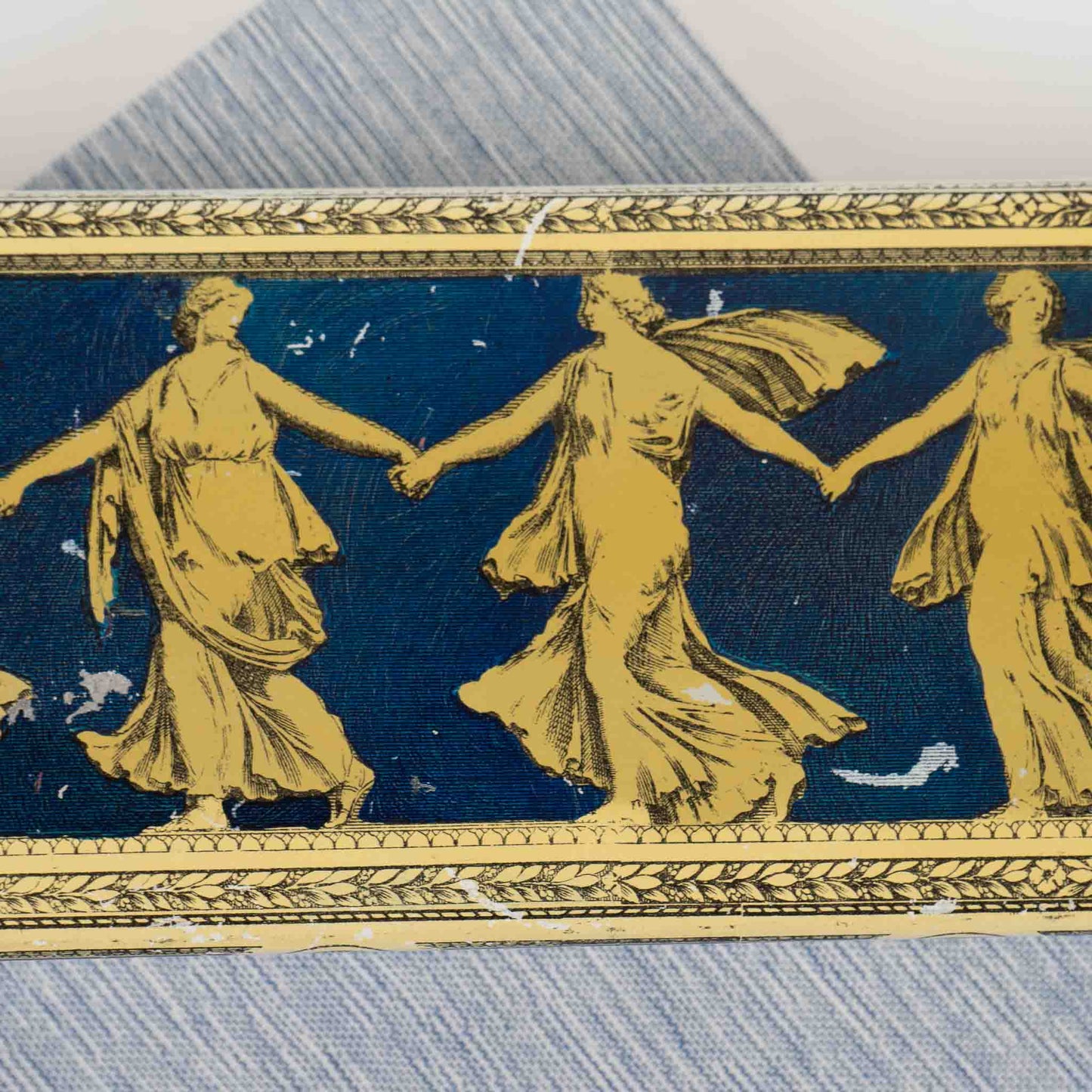close up of  metal decorative box with Greek dancing muses design 
