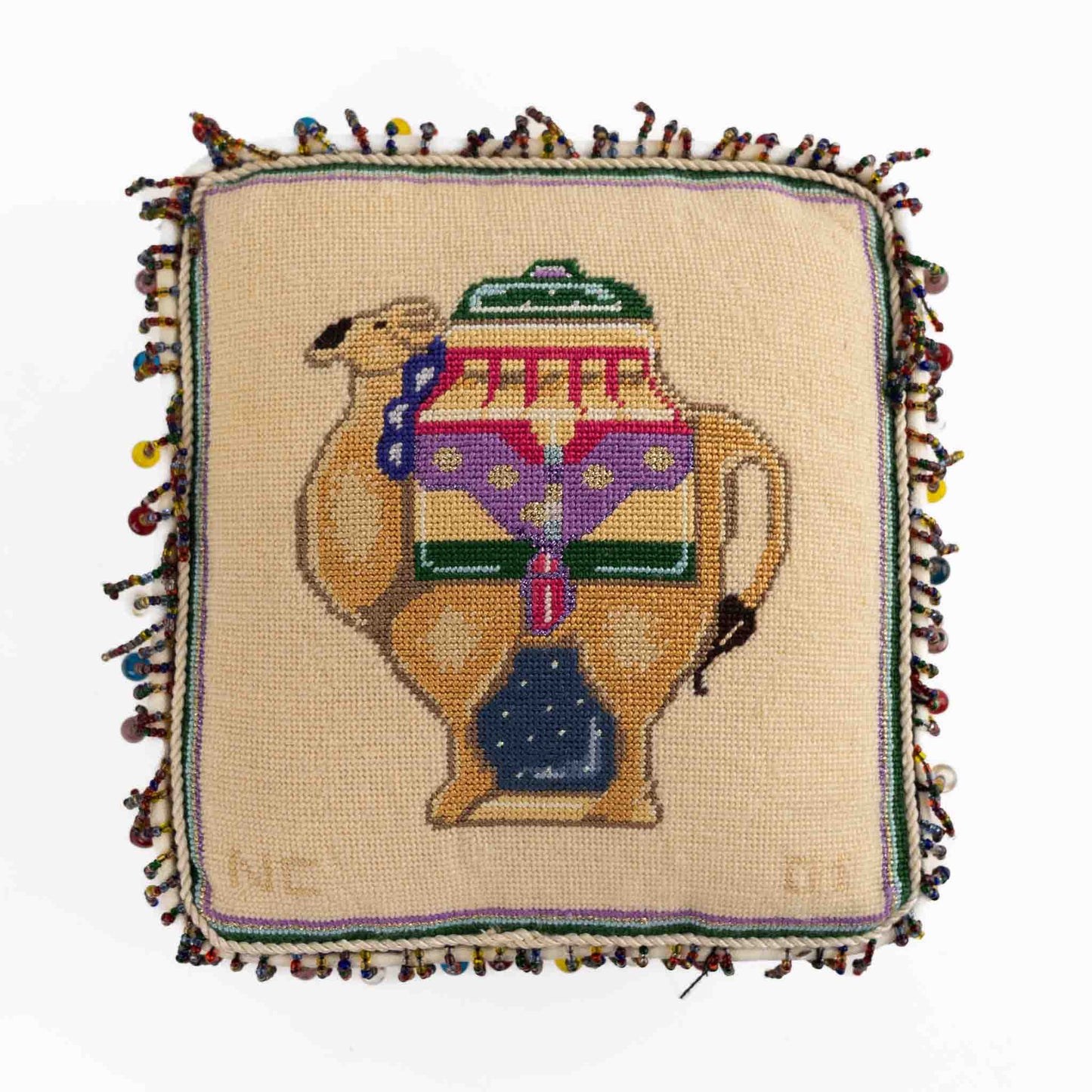 Vintage square needlepoint pillow with hand-stitched camel design and decorative beaded trim around edges