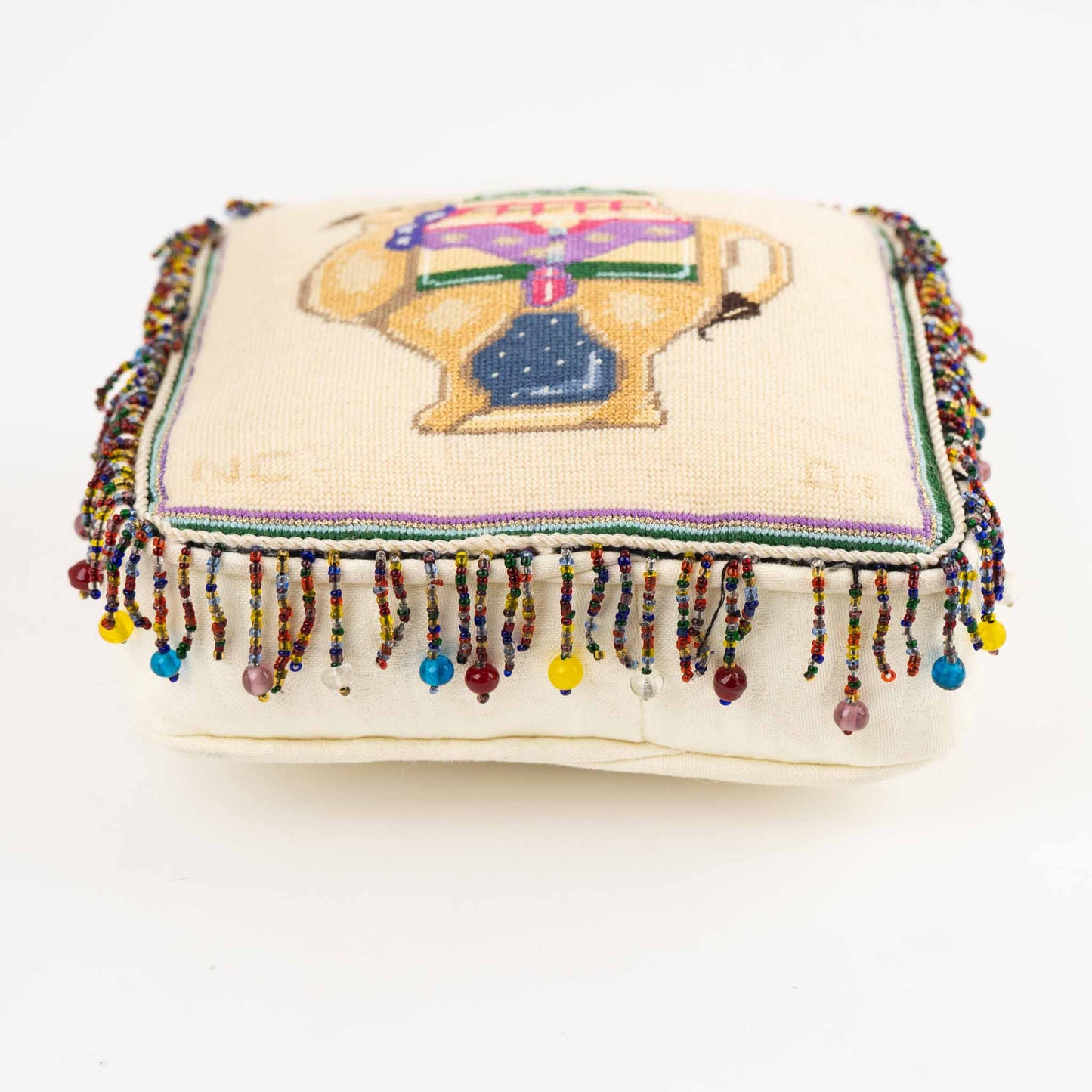 Vintage square needlepoint pillow with hand-stitched camel design and decorative beaded trim around edges