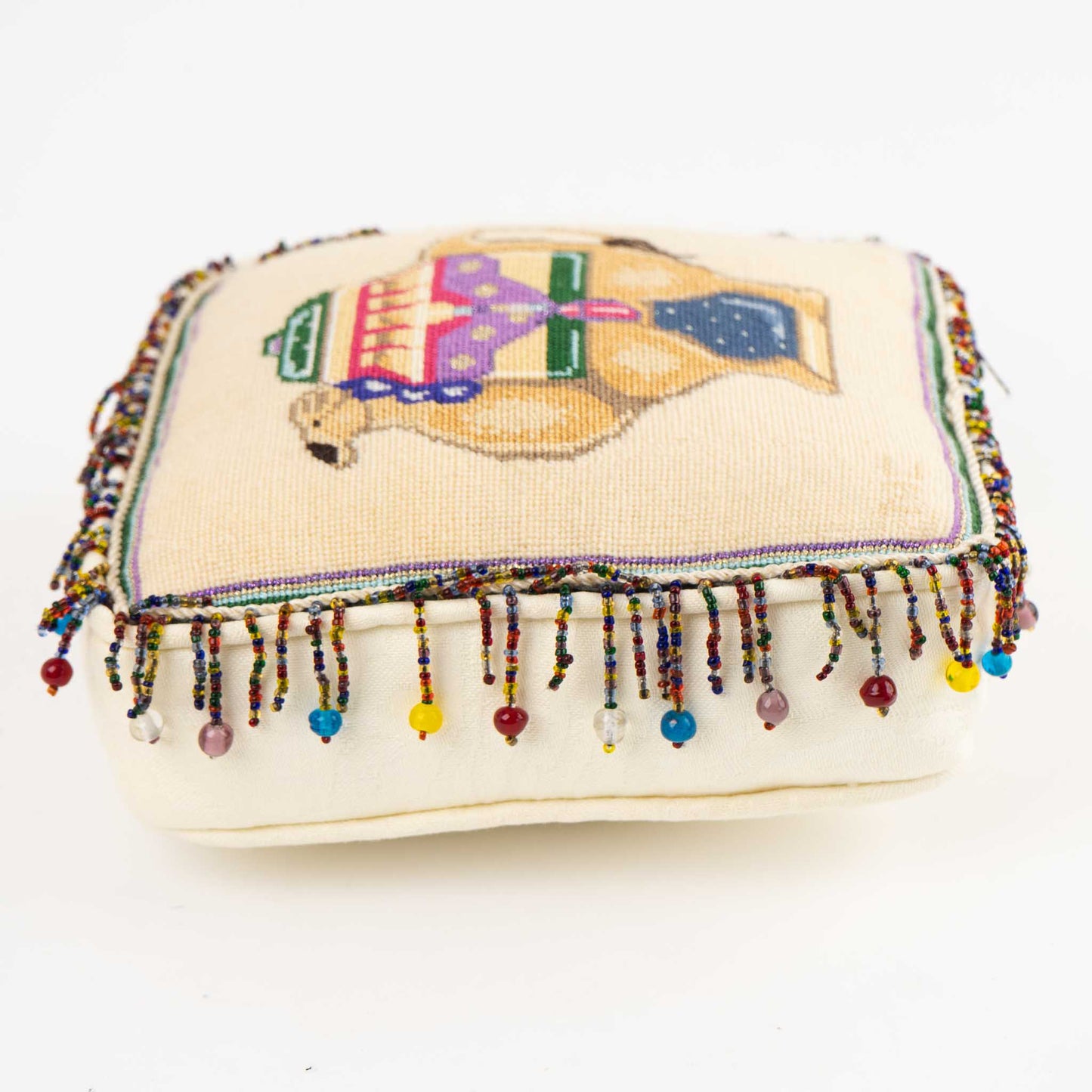 Vintage square needlepoint pillow with hand-stitched camel design and decorative beaded trim around edges