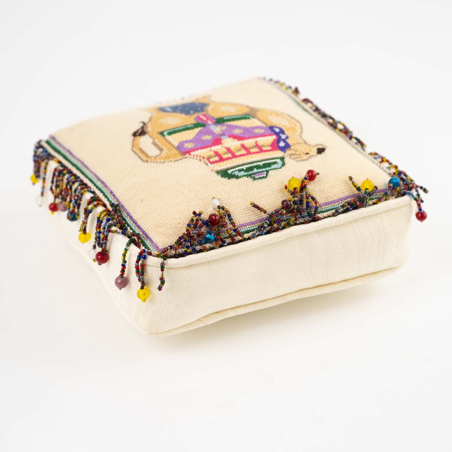 Vintage square needlepoint pillow with hand-stitched camel design and decorative beaded trim around edges