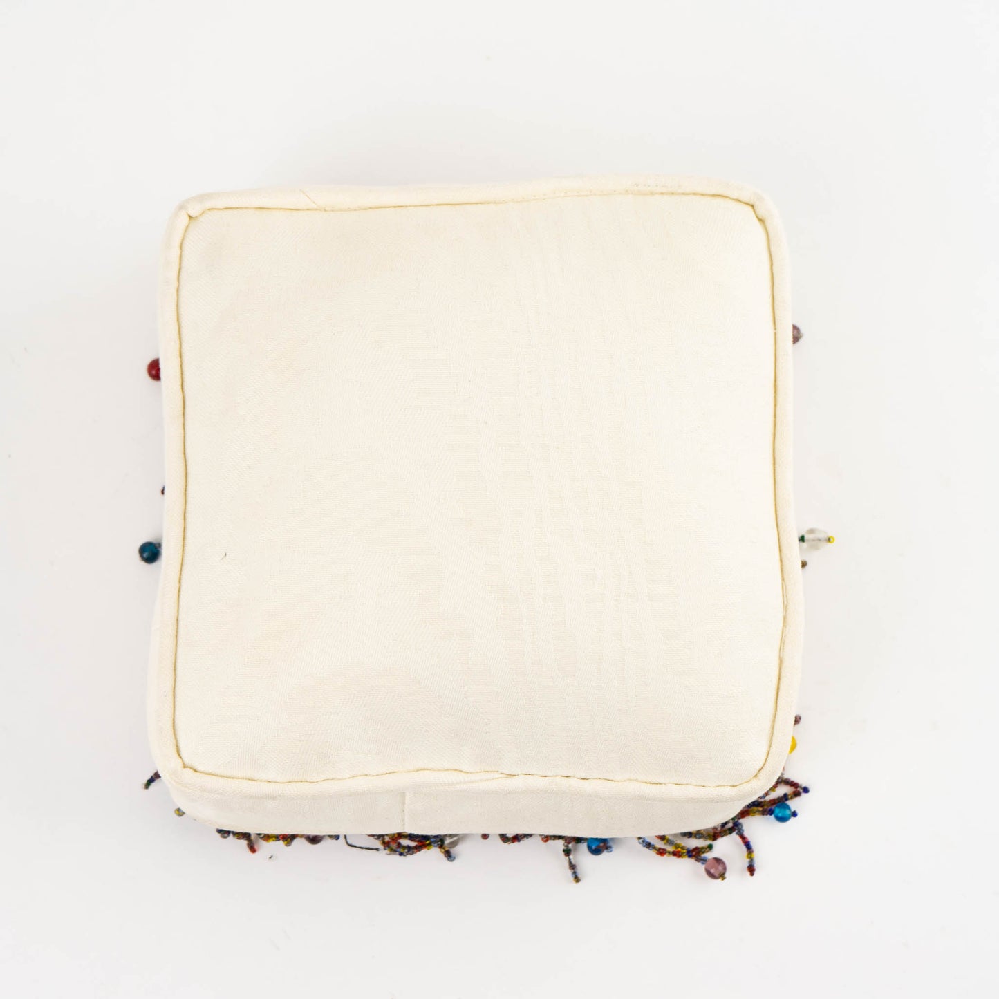 Vintage square needlepoint pillow with hand-stitched camel design and decorative beaded trim around edges